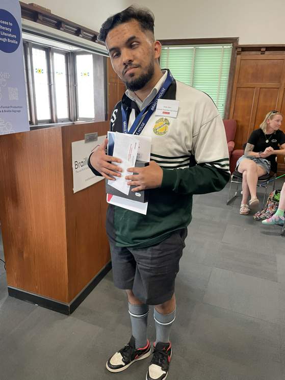 Arckan Noon holding his Veronica Maguire Remembrance Award