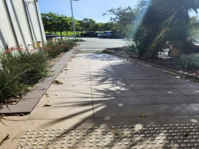 Photograph of curbs and ramp entrance with tactile indicators