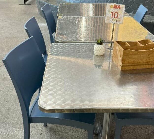 Photograph showing many tables in the caf&eacute; with rounded corners for safety