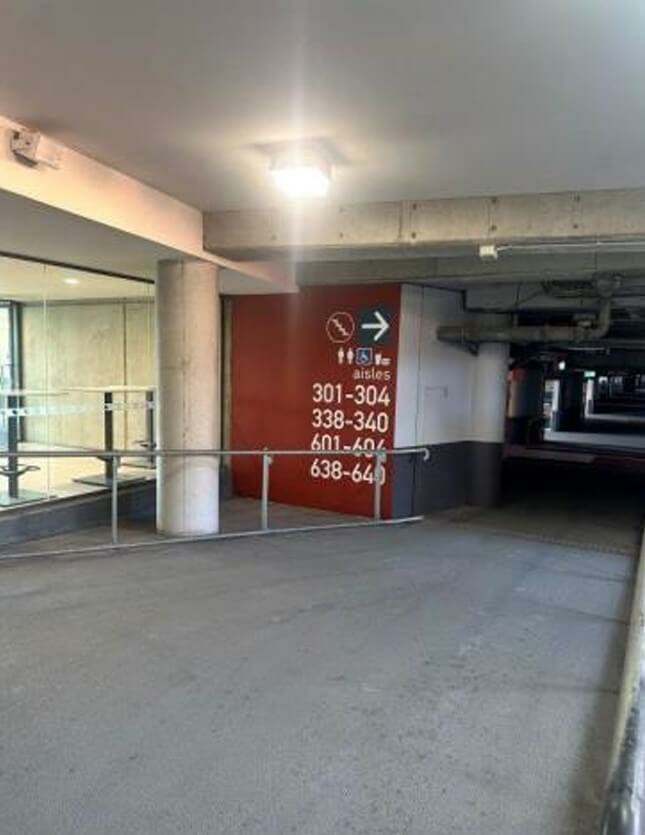 Photograph of Walkway with no Braille or tactile directional signage, although what is provided is large with good colour contrast.