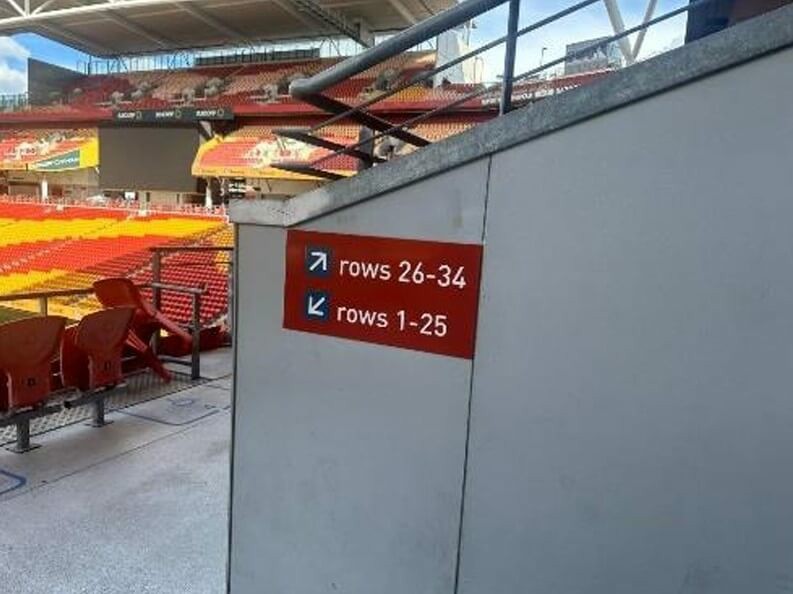 Photograph of Seat access. No Braille or tactile directional signage. Although there is good colour contrast on the signage.