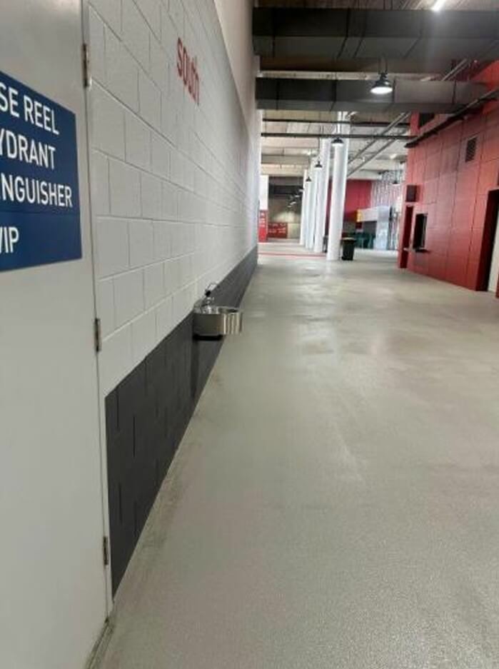 Photograph of Drinking fountain along walkway juts out from wall